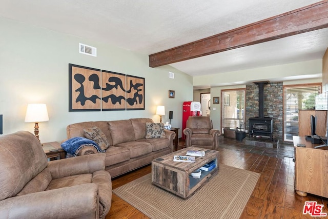 living room featuring a wood stove, dark hardwood / wood-style flooring, and beamed ceiling