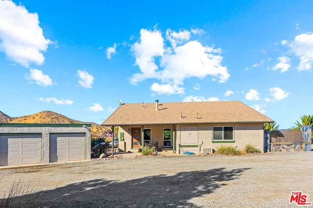 view of front of home with cooling unit and a mountain view