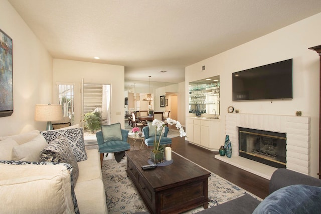 living room with hardwood / wood-style flooring and a fireplace