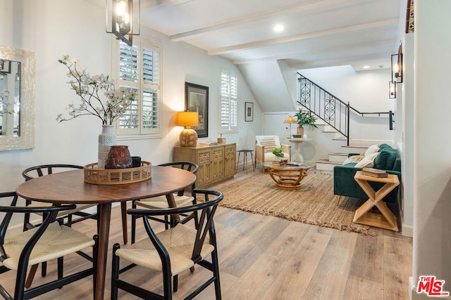 sitting room with vaulted ceiling with beams and light wood-type flooring