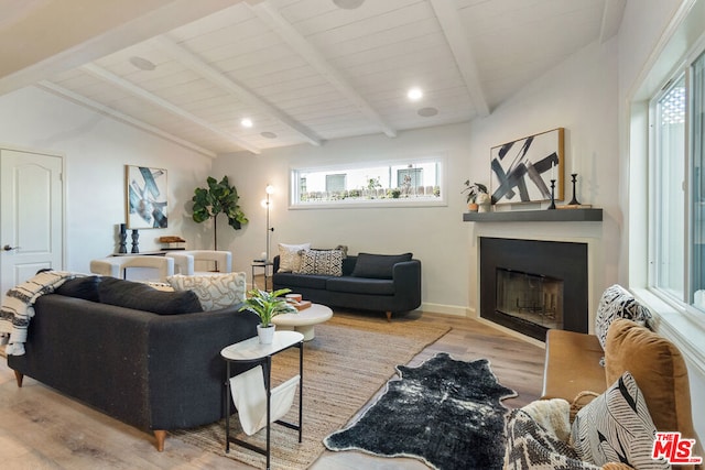 interior space featuring beamed ceiling, light hardwood / wood-style flooring, and plenty of natural light