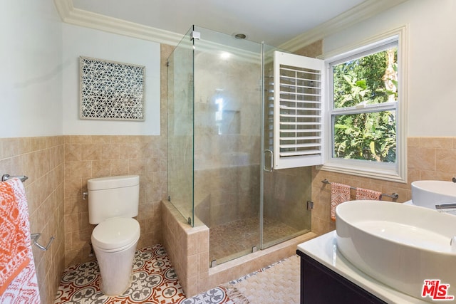 bathroom with toilet, crown molding, walk in shower, and tile walls