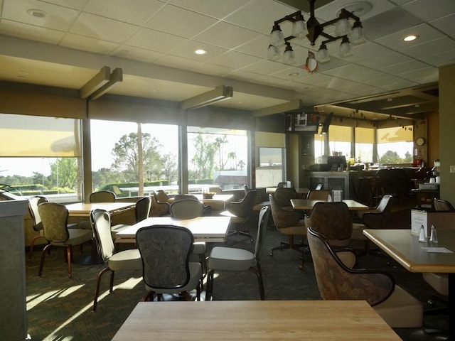 dining space with a drop ceiling