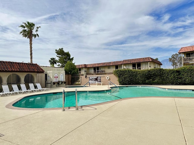 view of swimming pool with a patio