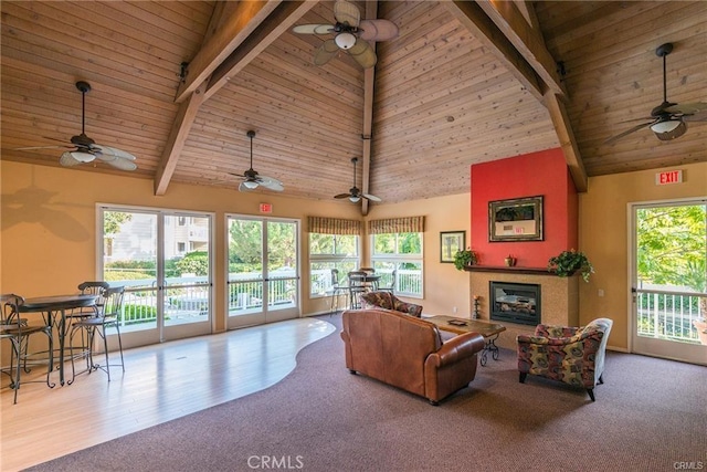 living room with wood ceiling, beamed ceiling, light colored carpet, and high vaulted ceiling