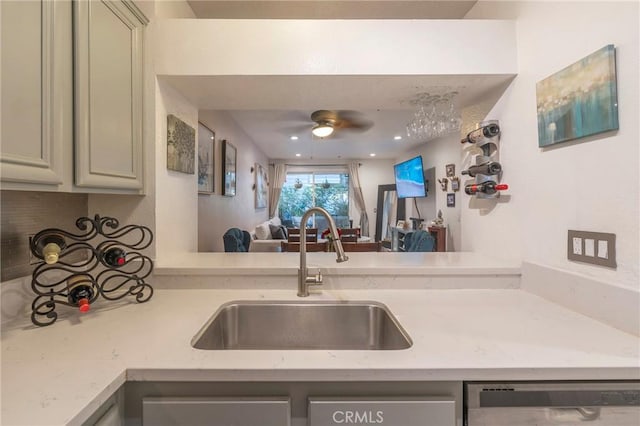 kitchen with ceiling fan, sink, dishwasher, and kitchen peninsula