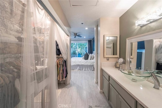 bathroom featuring vanity, hardwood / wood-style flooring, and ceiling fan