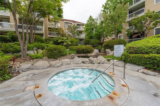 view of swimming pool featuring a patio area and a community hot tub