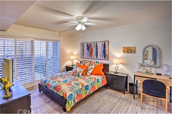 bedroom featuring wood-type flooring and ceiling fan