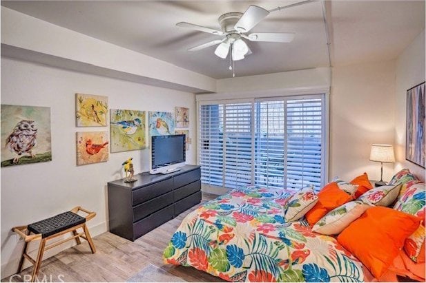 bedroom with light wood-type flooring and ceiling fan