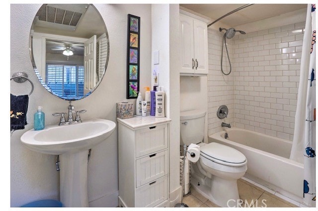 bathroom featuring toilet, ceiling fan, shower / bath combo with shower curtain, and tile patterned flooring