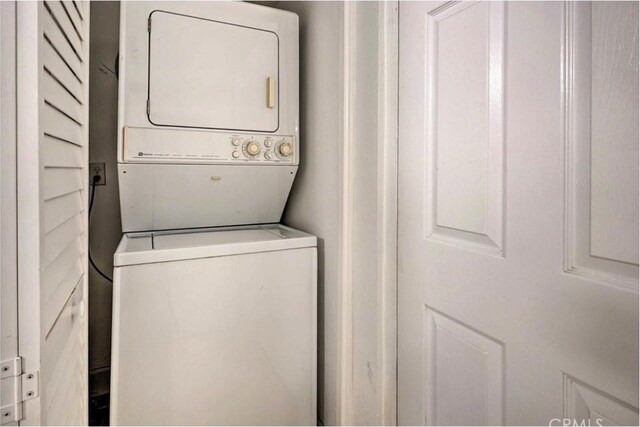 laundry area with stacked washer and dryer