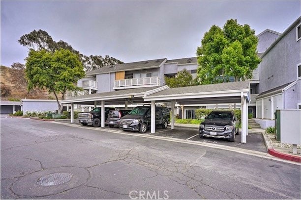 view of parking / parking lot featuring a carport