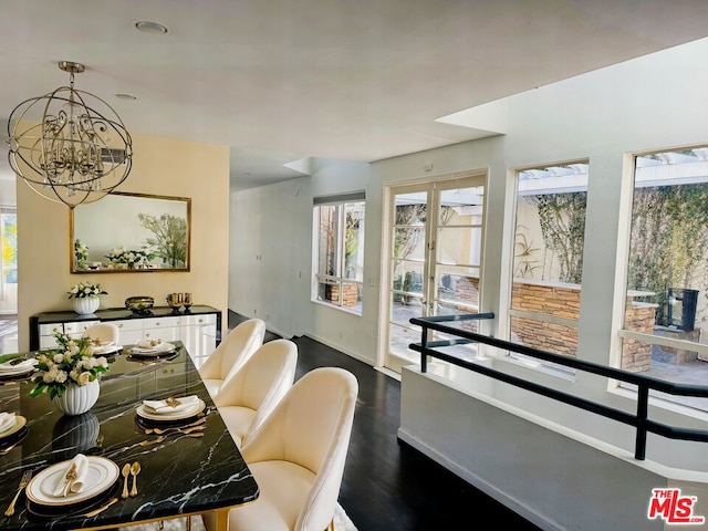 dining area with hardwood / wood-style flooring and a chandelier