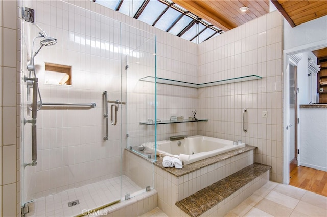 bathroom featuring wood ceiling, wood-type flooring, tile walls, vaulted ceiling, and plus walk in shower