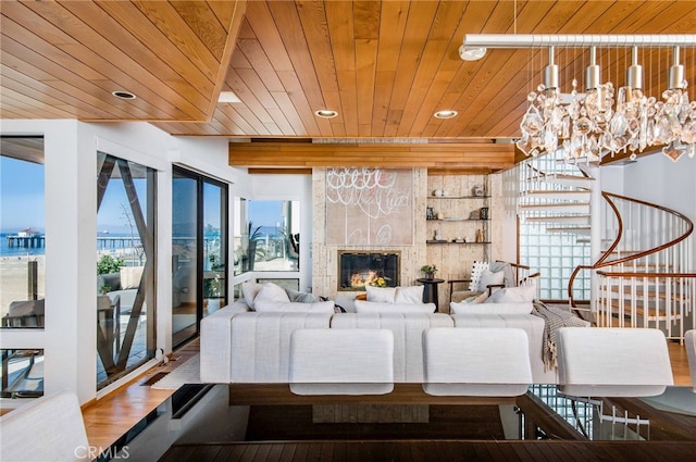 living room featuring a fireplace, wood ceiling, and wood-type flooring