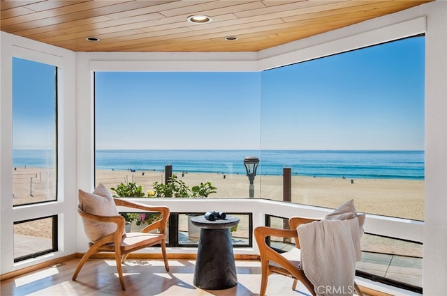 balcony featuring a water view and a view of the beach