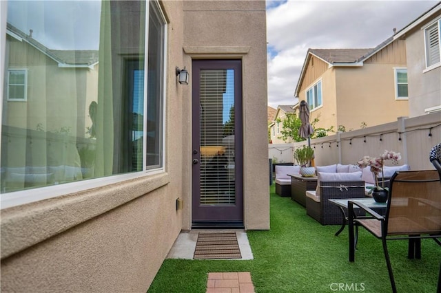 property entrance featuring an outdoor hangout area and stucco siding
