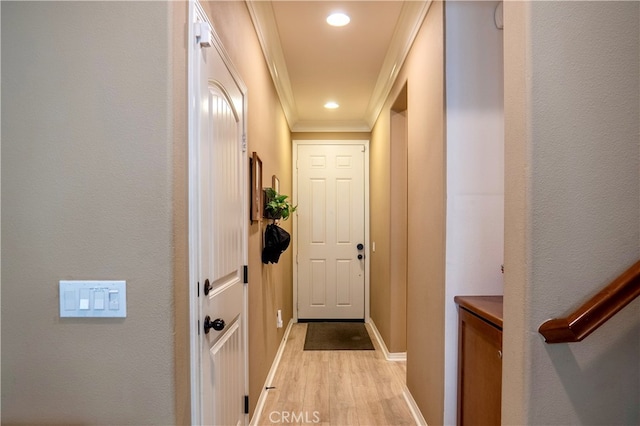 corridor featuring crown molding and light hardwood / wood-style flooring