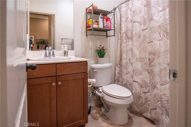 bathroom with vanity, toilet, and walk in shower