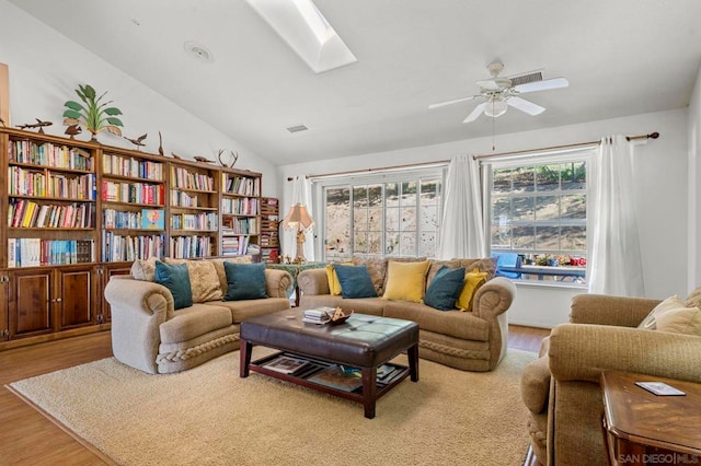 living room featuring ceiling fan, light wood-type flooring, and lofted ceiling