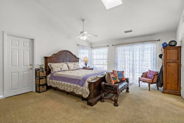 bedroom with ceiling fan, light colored carpet, vaulted ceiling, and multiple windows