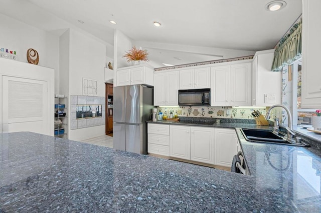 kitchen featuring backsplash, stainless steel fridge, sink, and white cabinetry