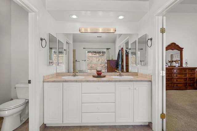 bathroom featuring toilet and vanity