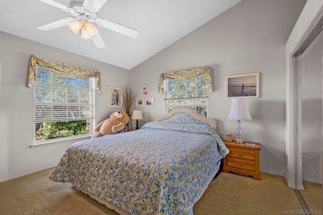 carpeted bedroom featuring ceiling fan, lofted ceiling, and a closet