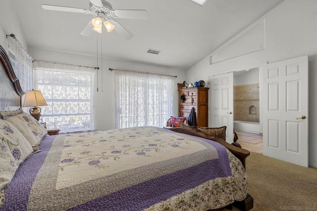 bedroom featuring vaulted ceiling, ceiling fan, carpet floors, and multiple windows