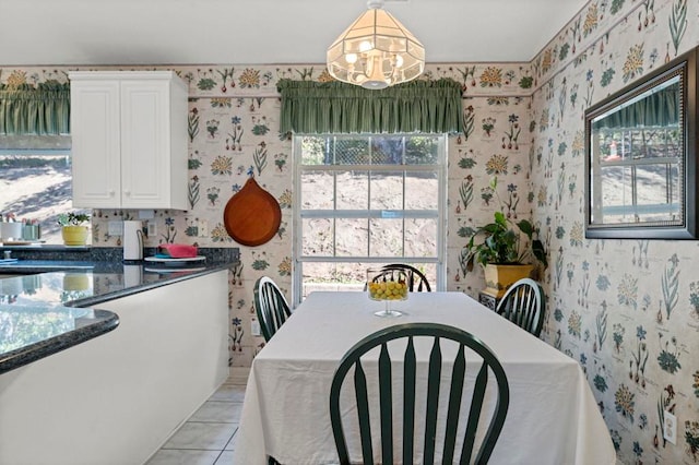 dining space featuring light tile patterned floors and a chandelier