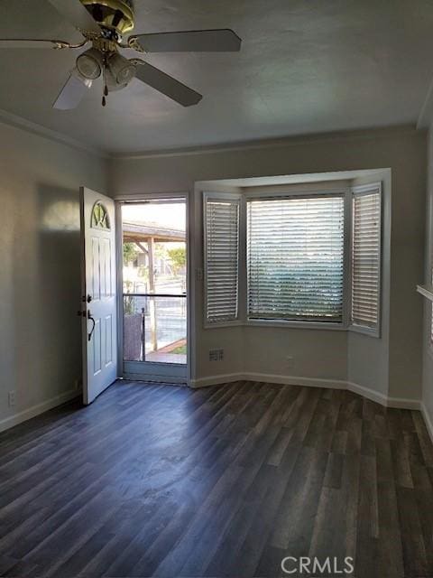 foyer featuring ceiling fan, dark hardwood / wood-style flooring, and ornamental molding