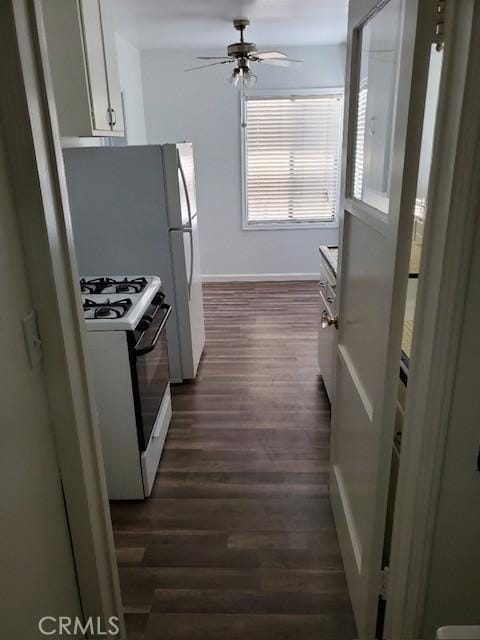 kitchen featuring white cabinets, ceiling fan, white appliances, and dark wood-type flooring