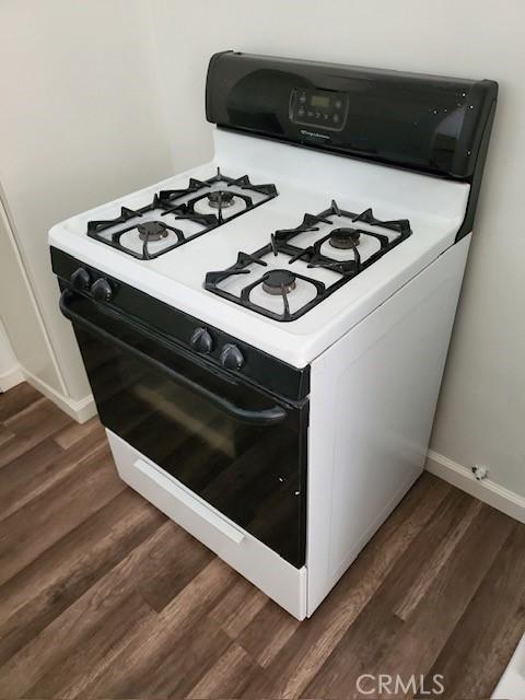 details featuring white gas range and dark wood-type flooring