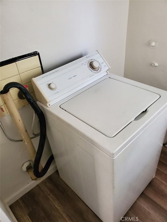 washroom featuring dark hardwood / wood-style floors and washer / dryer