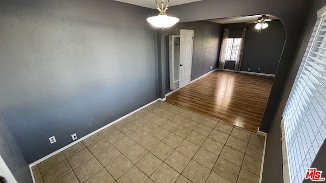 unfurnished room with ceiling fan and hardwood / wood-style floors