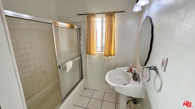 bathroom featuring enclosed tub / shower combo and tile patterned flooring