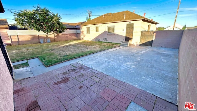 exterior space featuring a patio and a lawn