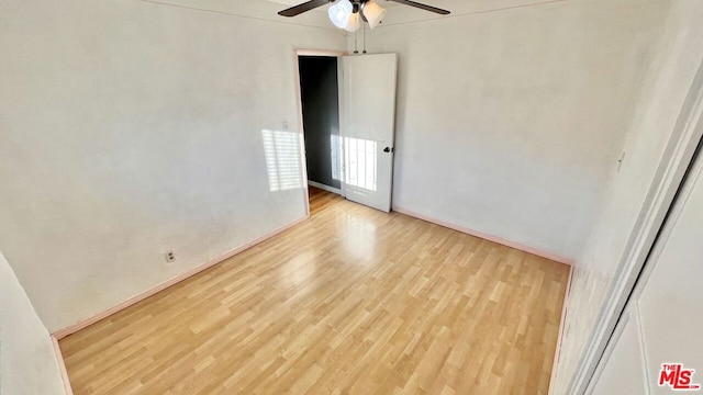 empty room with light wood-type flooring and ceiling fan