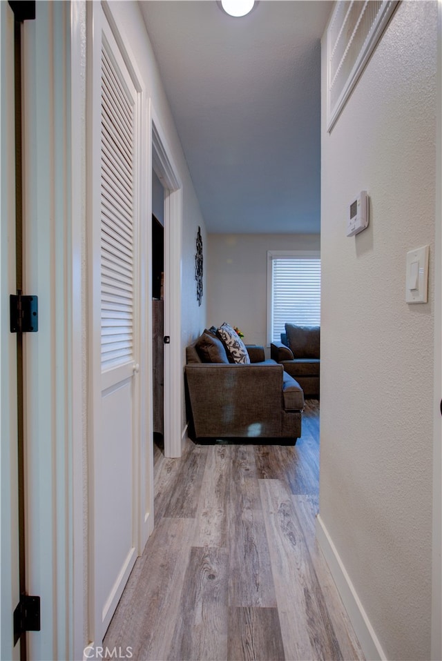 corridor with light wood-type flooring