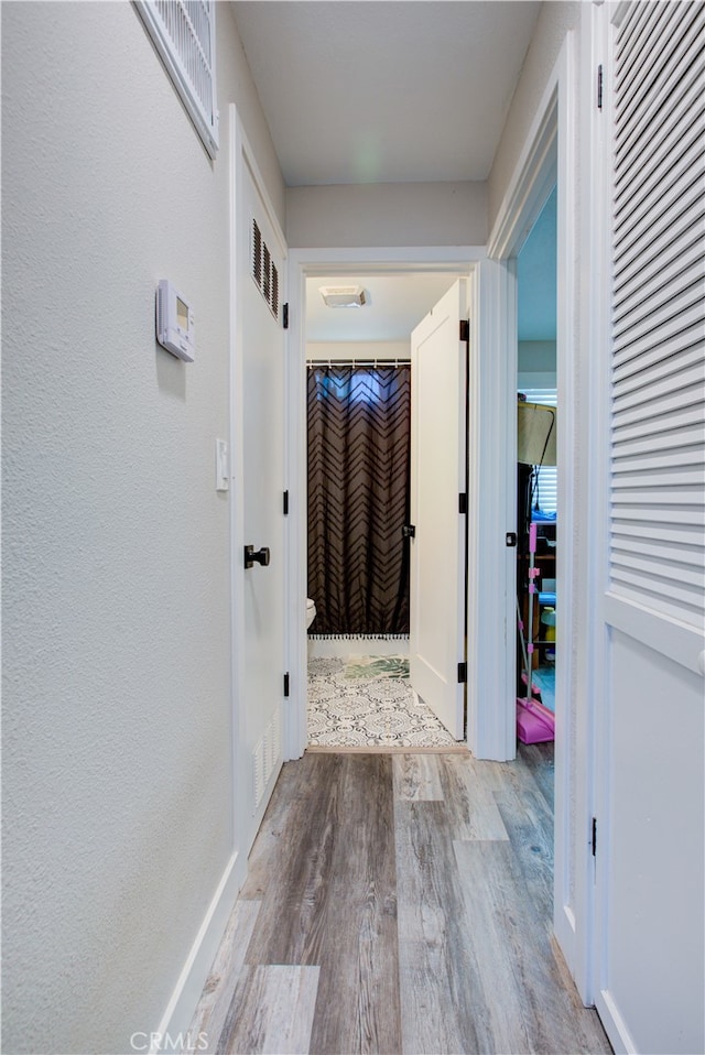 hall with light hardwood / wood-style flooring