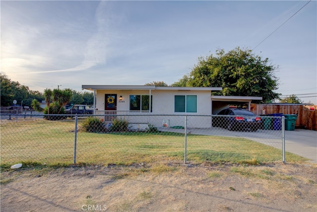 view of front of house with a front yard, covered porch, and a carport