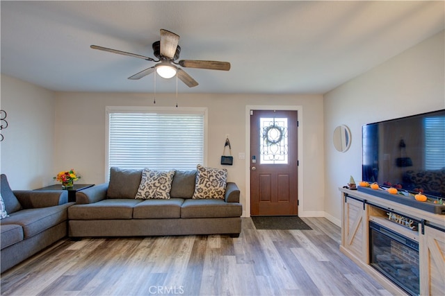 living room with light wood-type flooring and ceiling fan