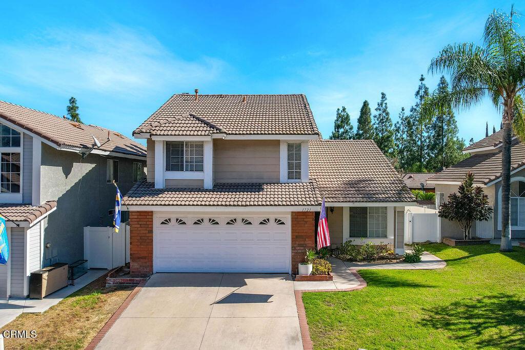 view of front property with a garage and a front yard