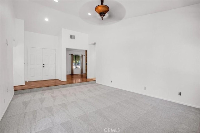 unfurnished room with ceiling fan and light colored carpet