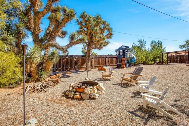 view of yard with a playground and a fire pit