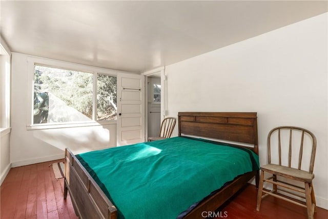 bedroom with dark hardwood / wood-style flooring