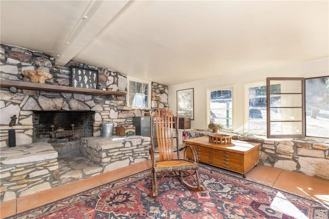 living room featuring beam ceiling and a fireplace