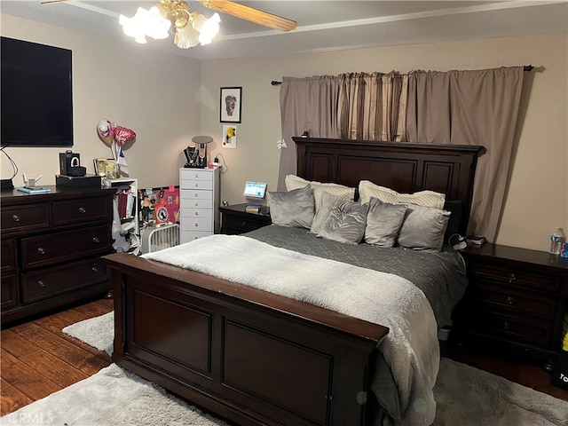 bedroom featuring ceiling fan and dark hardwood / wood-style floors