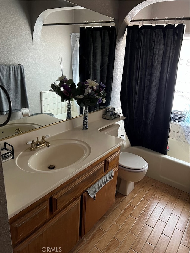 full bathroom featuring vanity, hardwood / wood-style floors, shower / bath combination with curtain, and toilet